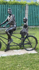 Bronze tandem sculpture and street-level Riga neighborhood scenes