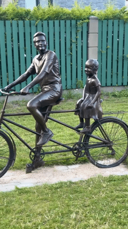 Bronze tandem sculpture and street-level Riga neighborhood scenes