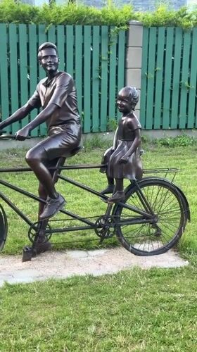 Bronze tandem sculpture and street-level Riga neighborhood scenes