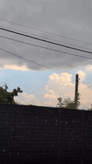 Summer rainstorm rolls through a backyard in Izmail, Ukraine