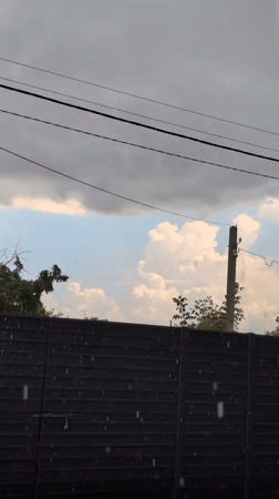 Summer rainstorm rolls through a backyard in Izmail, Ukraine