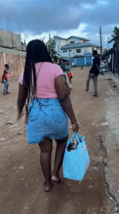 Afternoon chores and kids playing in an Ikotun compound