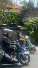 Man rides blue Vespa through Kerobokan streets early morning