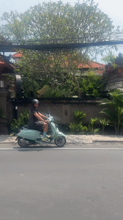 Man rides blue Vespa through Kerobokan streets early morning