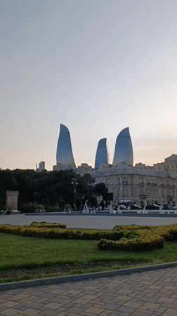 Afternoon stroll documented through Baku waterfront park near Flame Towers