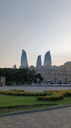 Afternoon stroll documented through Baku waterfront park near Flame Towers