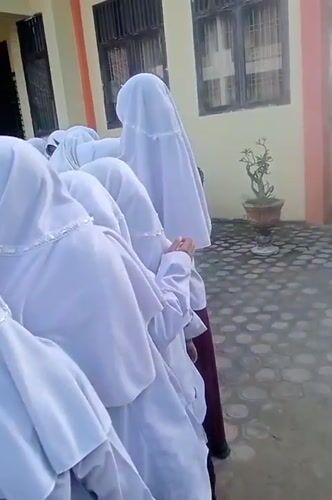 Students gather, hibiscus blooms captured in Keudekrueng, Indonesia
