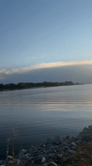Golden hour at a calm lakeside near Energetik, Russia