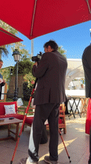 Interview filmed under red umbrella at Cannes resort
