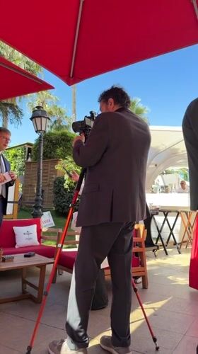 Interview filmed under red umbrella at Cannes resort
