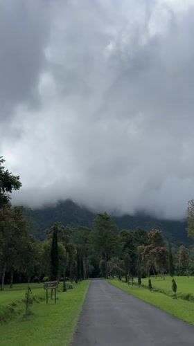 Tourists document cloudy morning at Indonesia's iconic Handara Gate