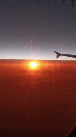 Airline passenger captures sunset view over Austrian Alps
