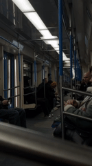 Moscow subway passengers using phones during early morning commute