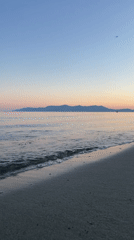 Witnesses capture serene Greek beach sunset in coordinated documentation