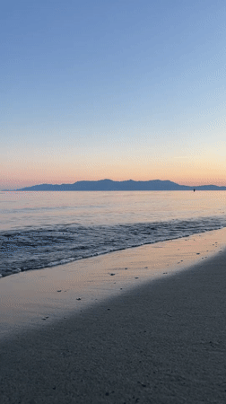 Witnesses capture serene Greek beach sunset in coordinated documentation