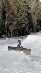 Snowboarders practice tricks at mountain park during morning hours