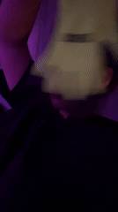 Woman with yellow glove observed in purple-lit Kiryat Bialik residence