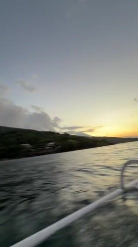 Woman films boat selfie off Indonesian coast at sunset