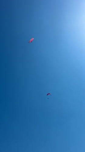 Paragliders and kayakers enjoy a sunny afternoon in Boreti