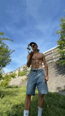 Tattooed street performer demonstrates kendama tricks in Lyon park