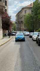 Morning traffic flows through Budapest's historic district near Parliament