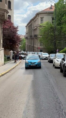 Morning traffic flows through Budapest's historic district near Parliament