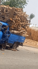 Man rests against firewood truck on Bauchi road