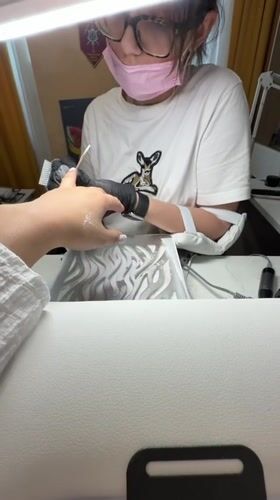 Woman gets manicure service in Vniissok, Russia