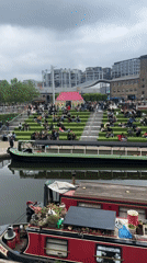 Solar-powered narrowboat spotted on London canal during overcast afternoon
