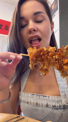 Woman enjoys street food lunch in Beijing's Dongcheng District