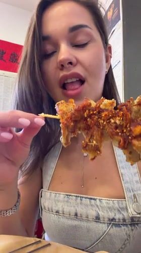 Woman enjoys street food lunch in Beijing's Dongcheng District
