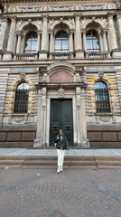 Woman conducts photo session amid Saint Petersburg's ornate architecture