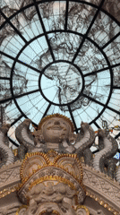 Exploring an ornate Thai temple with elephant statues and stained-glass dome