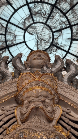 Exploring an ornate Thai temple with elephant statues and stained-glass dome
