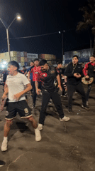 Young men dance at night in Arica port area