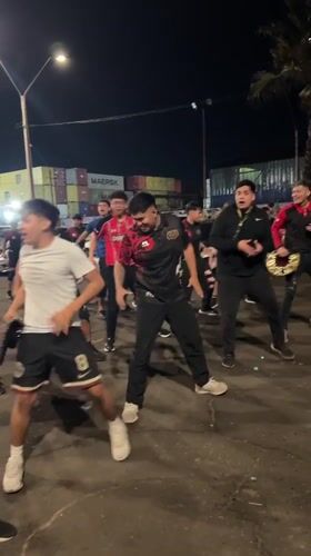 Young men dance at night in Arica port area