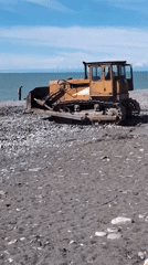 Yellow bulldozer spotted on black sand beach in Batumi