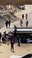 Residents collect water from tanker truck in Khan Yunis