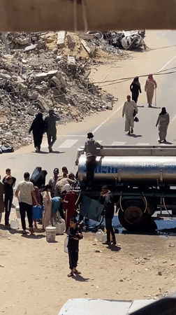 Residents collect water from tanker truck in Khan Yunis