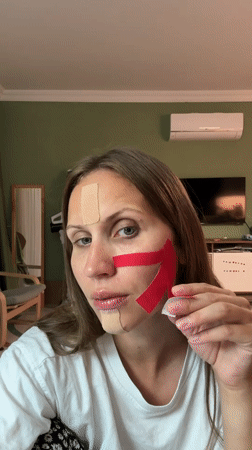 Woman applies therapeutic tape to face in Fethiye