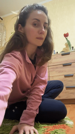 Woman sits on colorful rug in Kryvyi Rih