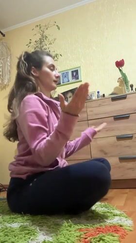 Woman sits on colorful rug in Kryvyi Rih