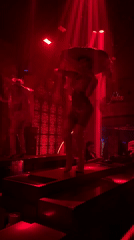 Sequined performers on stage at a red-lit North Kuta club