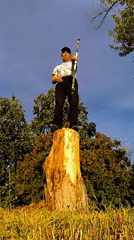 Street juggler performs with striped stick in Karaganda