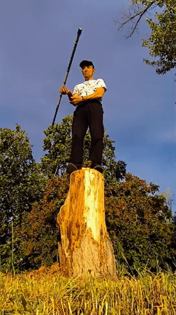 Street juggler performs with striped stick in Karaganda