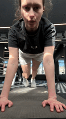 Woman exercises at Yekaterinburg gym doing push-ups on mat