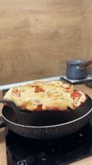 Man cooks pizza rolls in kitchen, Varna Bulgaria