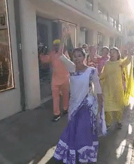Group in traditional Indian dress walks through Tel Aviv