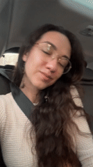 Woman in gold-rimmed glasses observed in car, Tel Aviv