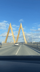 Vehicle crosses Millennium Bridge in Kazan on sunny afternoon